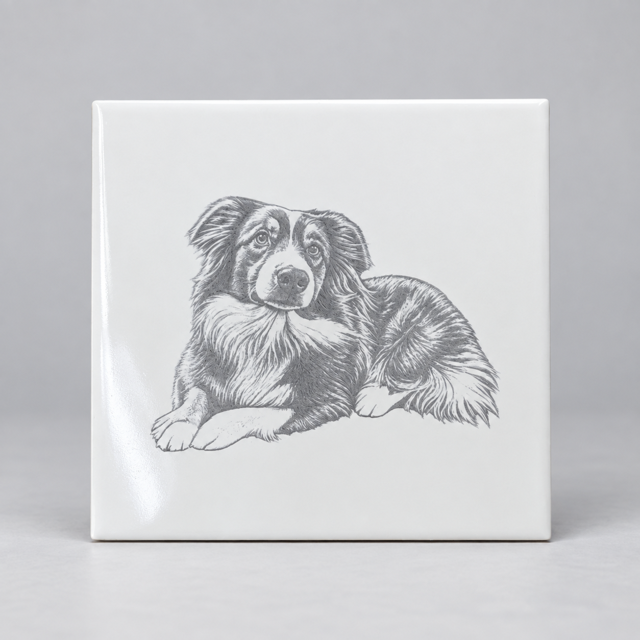 White ceramic tile with a detailed engraved dog portrait