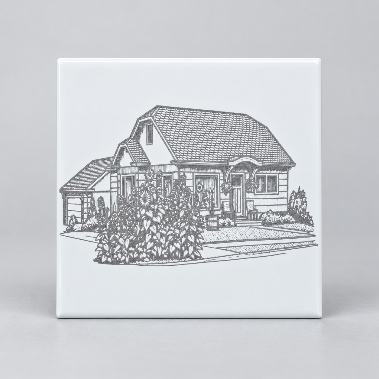 White ceramic tile engraved with a house and landscaping