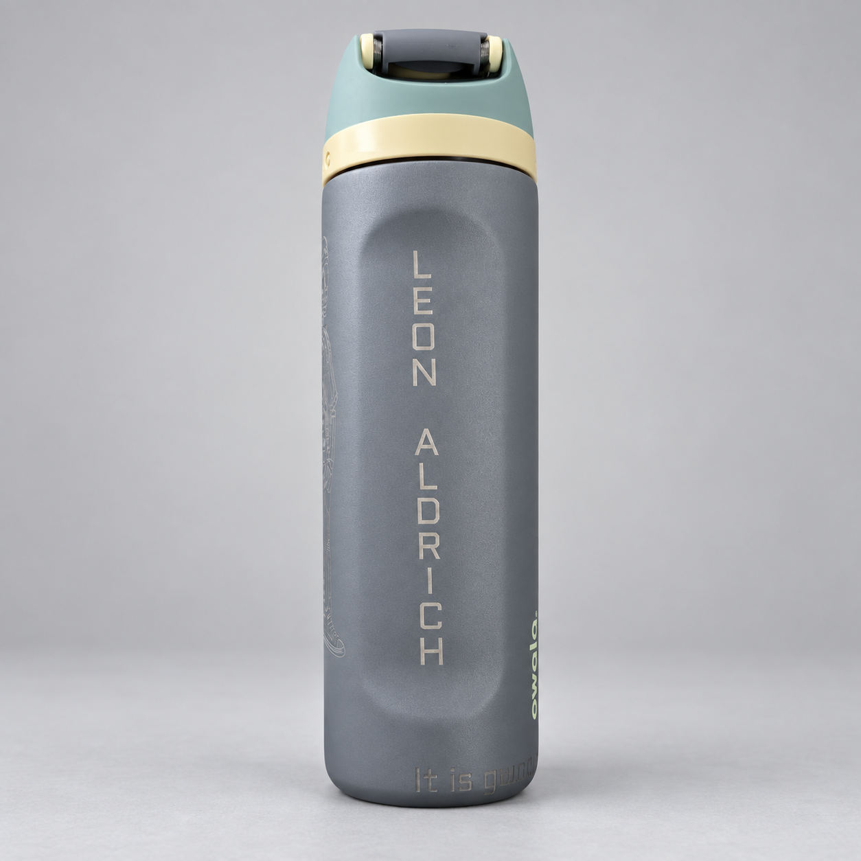 Gray bottle with green and cream lid engraved Leon Aldrich