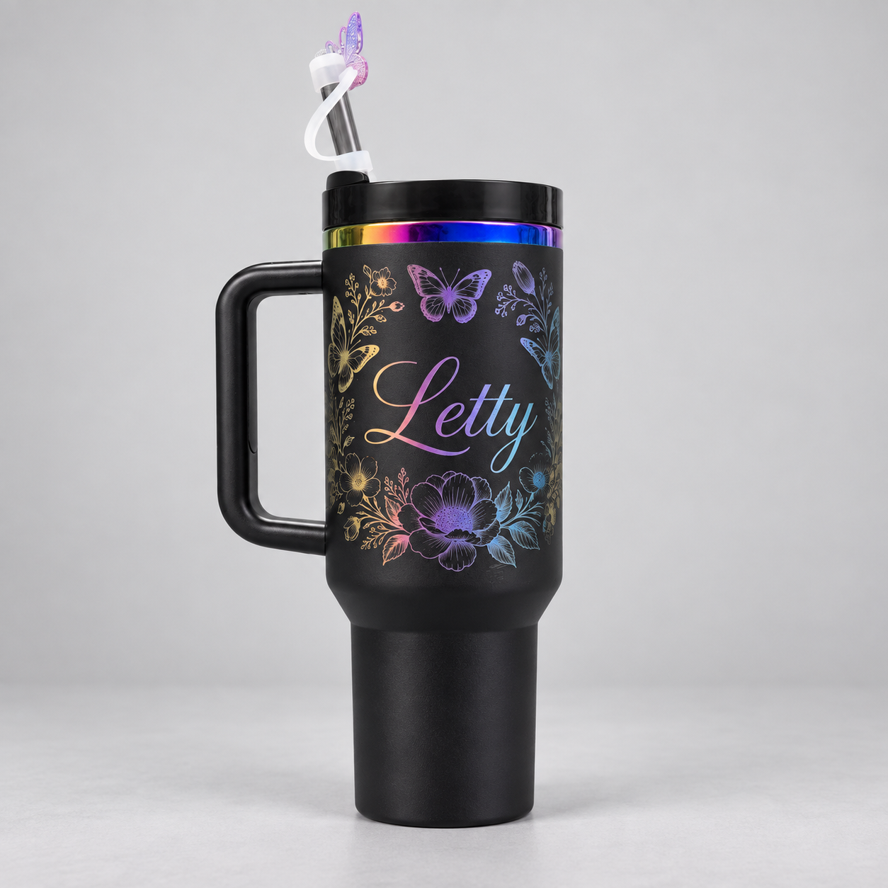 Personalized black tumbler with iridescent floral engraving and the name Letty